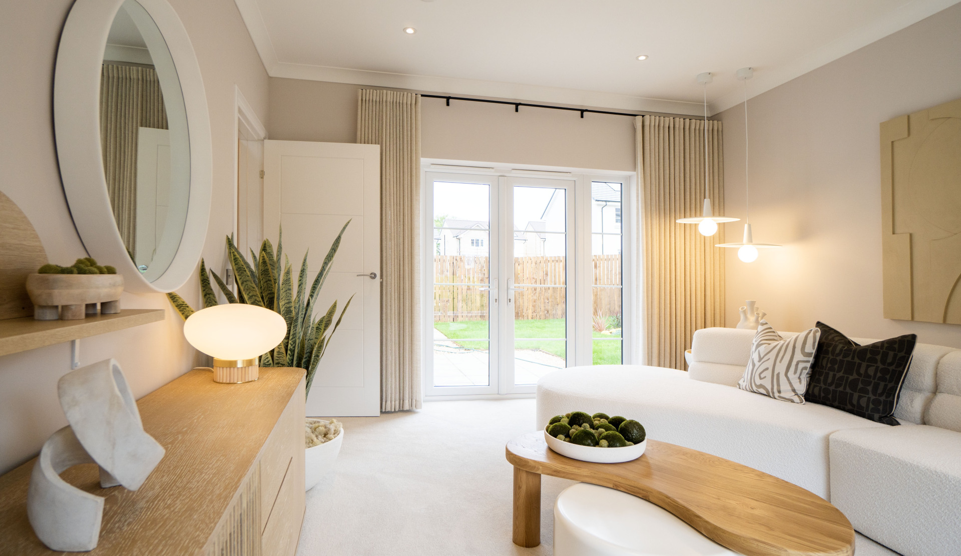 With French doors the living room in the Ness is flooded with natural light. 